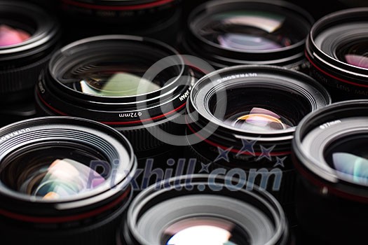 Modern camera lenses with reflections, low key image Modern camera lenses with reflections, low key image