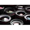 Modern camera lenses with reflections, low key image