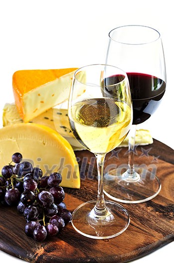 Wineglasses with red and white wine and assorted cheeses Wineglasses with red and white wine and assorted cheeses