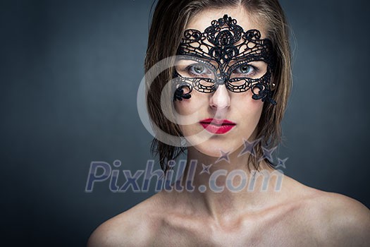 Attractive young woman with mask (color toned image) Attractive young woman with mask (color toned image)