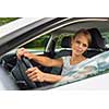 Young woman driving her car, on her way home from work - doing the daily commute