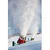 Snow-machine bursting artificial snow  over a skiing slope to alow for the skiing season to start