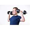 Close up of young man lifting weights over white background