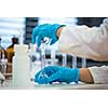 Hands of a female researcher doing research in a lab (shallow DOF; color toned image)