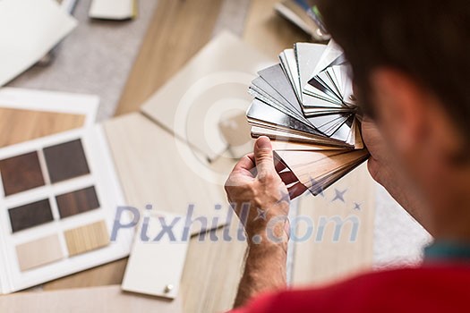 Man chosing the right flooring for his house/appartement Man chosing the right flooring for his house/appartement