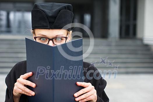 Pretty, young woman celebrating joyfully her graduation - cheking her diploma, happy/impressed with the title she received (color toned image; shallow DOF) Pretty, young woman celebrating joyfully her graduation - cheking her diploma, happy/impressed with the title she received (color toned image; shallow DOF)