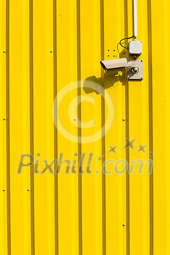 Security camera on a yellow wall Security camera on a yellow wall