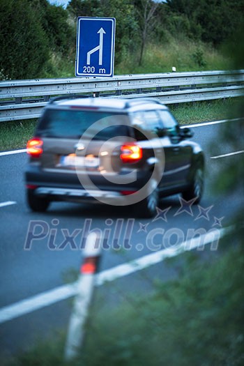 Blurred car on a highway (motion blur technique used to convey movement) Blurred car on a highway (motion blur technique used to convey movement)