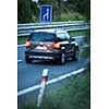 Blurred car on a highway (motion blur technique used to convey movement)