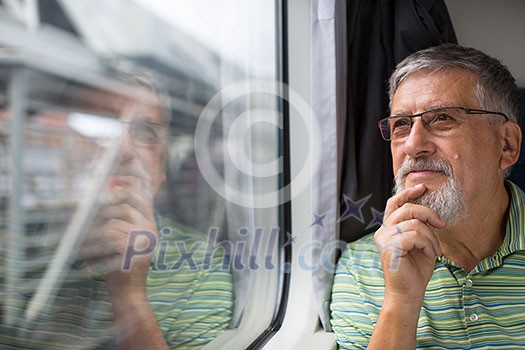 Senior man enjoying a train travel - leaving his car at home, he savours the time spent travelling, looks out of the window, has time to admire the landscape passing by Senior man enjoying a train travel - leaving his car at home, he savours the time spent travelling, looks out of the window, has time to admire the landscape passing by