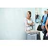 Young female passenger at the airport, about to check-in