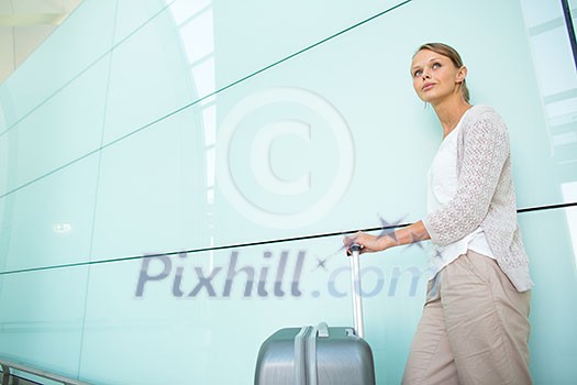 Young female passenger at the airport, about to check-in Young female passenger at the airport, about to check-in