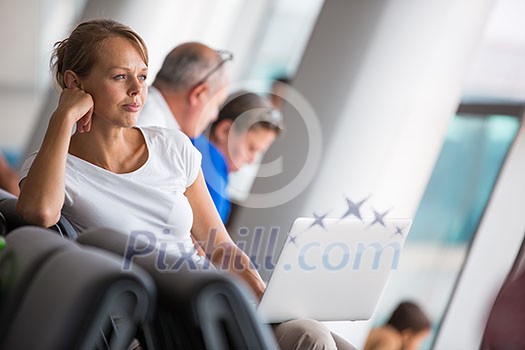 Young female passenger at the airport, about to check-in Young female passenger at the airport, about to check-in