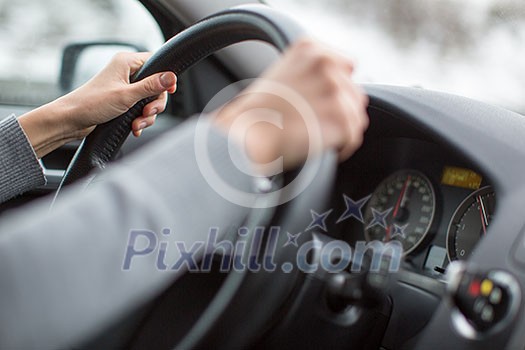 Driver's hands driving a car on a highway (color toned image; shallow DOF) Driver's hands driving a car on a highway (color toned image; shallow DOF)