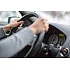 Driver's hands driving a car on a highway (color toned image; shallow DOF)