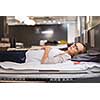 Pretty, young woman choosing the right furniture for her apartment in a modern home furnishings store (color toned image; shallow DOF)