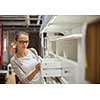 Pretty, young woman choosing the right furniture for her apartment in a modern home furnishings store (color toned image; shallow DOF)