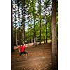 Young woman running outdoors in a forest, going fast (motion blurred image)