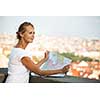 Pretty young female tourist studying a map, enjoying discovering a new city, looking excited (shallow DOF; color toned image)