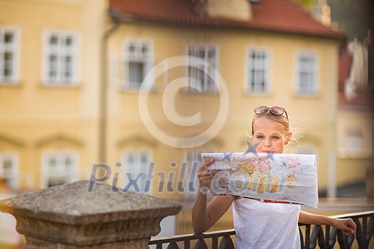 Pretty young female tourist studying a map, enjoying discovering a new city, looking excited (shallow DOF; color toned image) Pretty young female tourist studying a map, enjoying discovering a new city, looking excited (shallow DOF; color toned image)