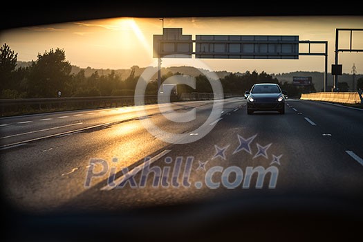 Cars on a highway at sunset (shallow DOF; color toned image) Cars on a highway at sunset (shallow DOF; color toned image)