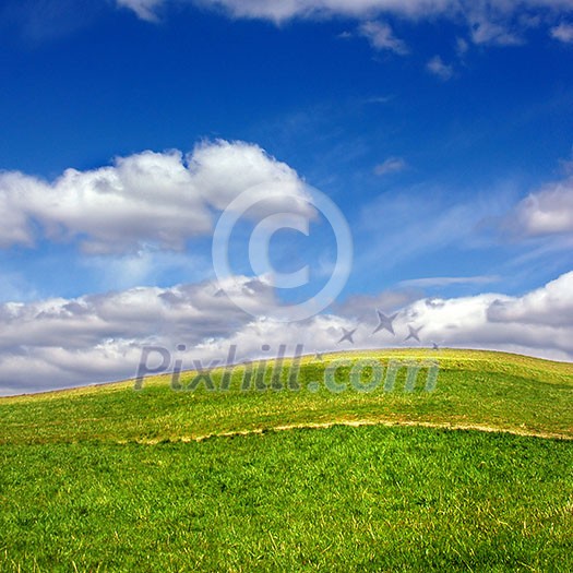 Green field against blue sky and clouds Green field against blue sky and clouds