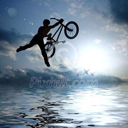 silhouette of boy with bicycle jumping in air silhouette of boy with bicycle jumping in air
