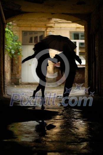 silhouette of couple with umbrella running from rain silhouette of couple with umbrella running from rain