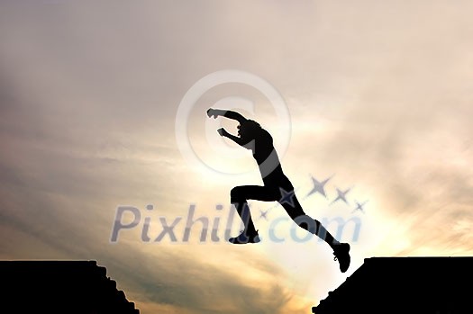 silhouette of jumping boy agains silhouette of jumping boy agains