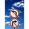 two opposite road signs against blue sky and clouds