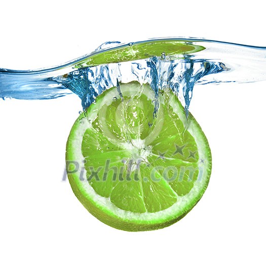 Fresh lime dropped into water with splash isolated on white Fresh lime dropped into water with splash isolated on white