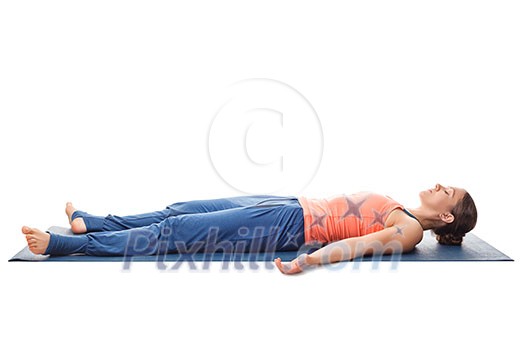 Beautiful sporty fit yogini woman relaxes in yoga asana Savasana - corpse pose isolated on white Beautiful sporty fit yogini woman relaxes in yoga asana Savasana - corpse pose isolated on white