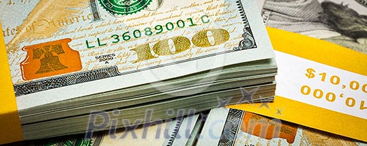 Creative business finance making money concept - letterbox panoramic image of new 100 US dollars 2013 edition banknotes (bills) bundles close up Creative business finance making money concept - letterbox panoramic image of new 100 US dollars 2013 edition banknotes (bills) bundles close up