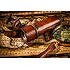 Travel geography navigation concept background - old vintage retro compass with sundial, spyglass and magnifying glass on ancient world map