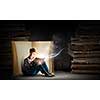 Teenager boy wearing jeans and shirt and reading book
