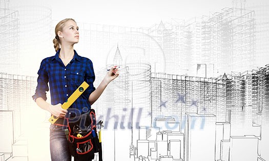 Young pretty woman engineer with tool belt on waist Young pretty woman engineer with tool belt on waist