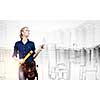 Young pretty woman engineer with tool belt on waist