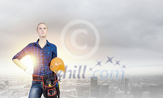 Young pretty woman engineer with tool belt on waist Young pretty woman engineer with tool belt on waist