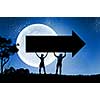 Silhouettes of young couple against full moon