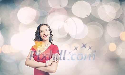 Young woman in red dress against bokeh background Young woman in red dress against bokeh background