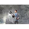 Young determined businessman with wrench in hands