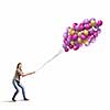 Young woman in casual holding bunch of colorful balloons
