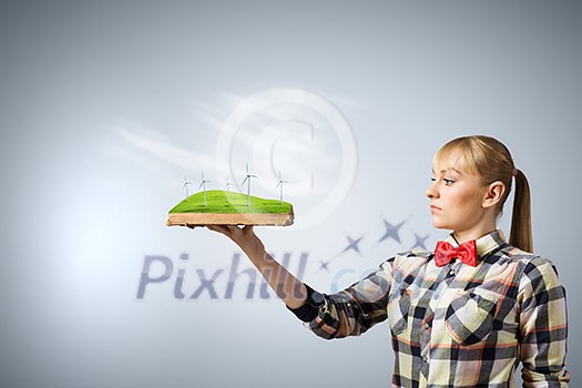 Young woman in casual holding opened book with windmills Young woman in casual holding opened book with windmills