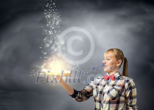 Woman in casual wear holding opened book in hands Woman in casual wear holding opened book in hands