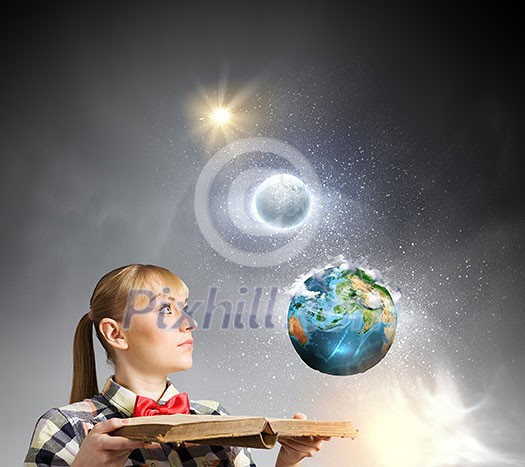 Woman in casual wear holding opened book in hands. Elements of this image are furnished by NASA Woman in casual wear holding opened book in hands. Elements of this image are furnished by NASA
