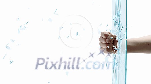 Close up of male fist breaking glass with punch Close up of male fist breaking glass with punch