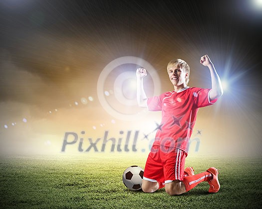 Football player standing on knees and screaming with joy Football player standing on knees and screaming with joy