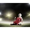Football player standing on knees and screaming with joy