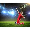 Football player standing on knees and screaming with joy