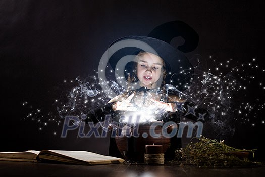 Little Halloween witch reading conjure above pot Little Halloween witch reading conjure above pot